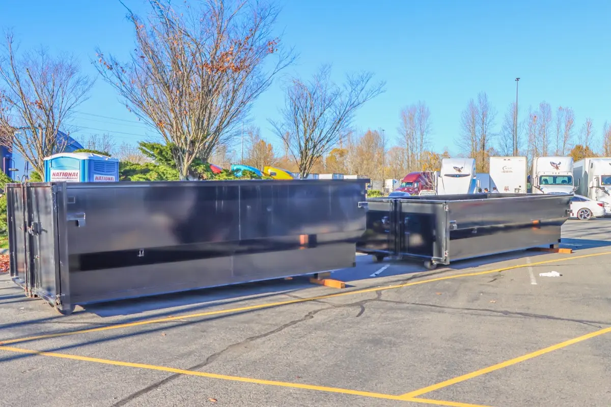 Professional dumpster rental service with roll-off container on residential driveway in Oxon Hill